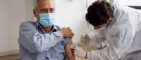 man receiving a shot of a vaccine